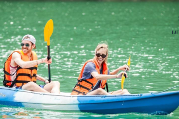 Couple kayaking in Ha Long Bay during Alova Premium Cruise