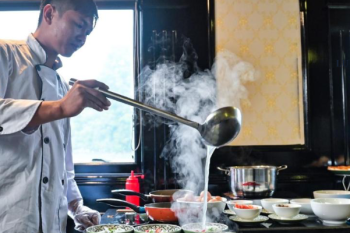 Chef preparing Vietnamese cuisine on Alova Premium Cruise