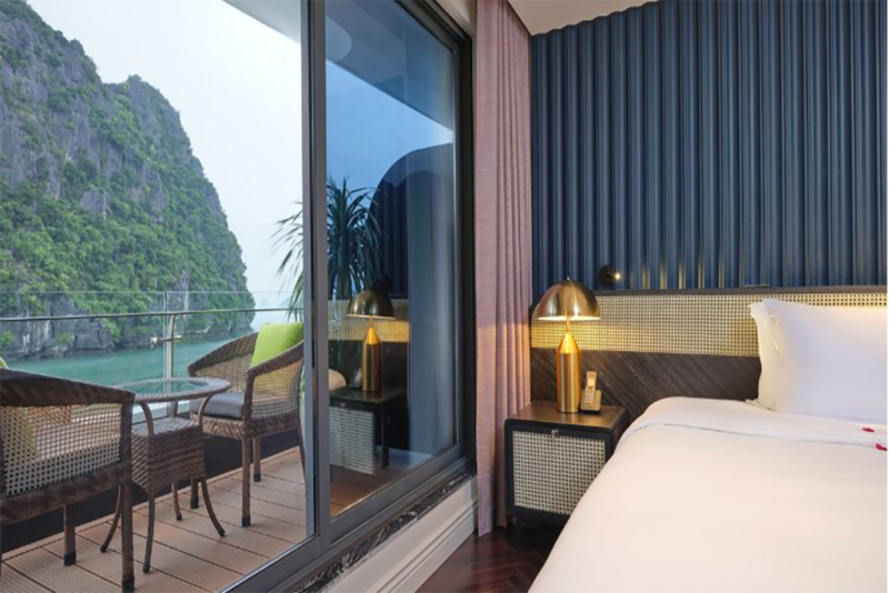Elegant bedroom with balcony overlooking Ha Long Bay on Elite of the Seas Cruise