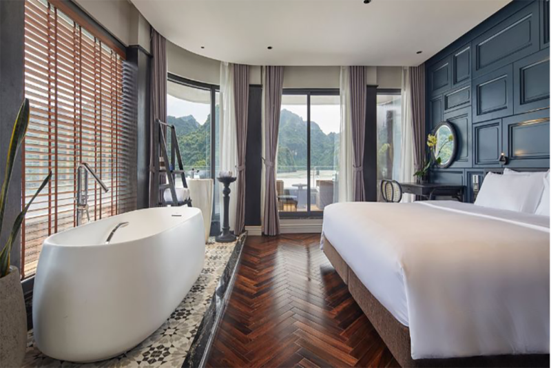 Luxurious bedroom with bathtub and panoramic Ha Long Bay view on Elite of the Seas Cruise