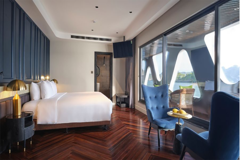 Luxurious bedroom with elegant decor and panoramic views of Ha Long Bay on the Elite of the Seas Cruise.