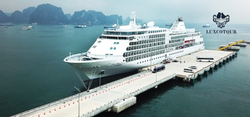 A large cruise ship docked at a pier in Ha Long Bay, Vietnam