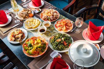 A colorful spread of traditional Vietnamese dishes served on the Reina day cruise in Halong Bay