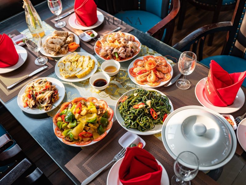 A colorful spread of traditional Vietnamese dishes served on the Reina day cruise in Halong Bay