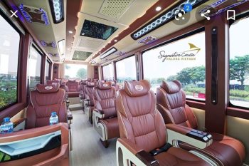 Interior of a luxurious 16-seater Felix Limousine van with leather seats and modern amenities, offering a comfortable travel experience from Halong Bay to Ninh Binh.