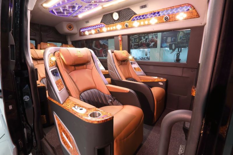 Luxurious interior of a private van with leather seats and ambient lighting used for transfer between Hanoi and Halong Bay