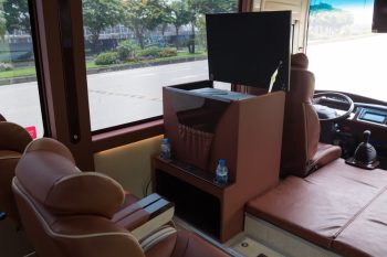 Interior view of the Felix Limousine 16-seater luxury bus for Hanoi to Ha Long Bay transfer, showing comfortable leather seats and onboard amenities