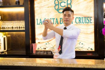 Bartender preparing a drink on the La Casta Daily Cruise, showcasing the luxurious bar setup.