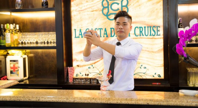 Bartender preparing a drink on the La Casta Daily Cruise, showcasing the luxurious bar setup.