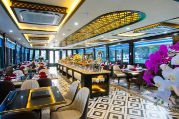 Elegant dining area and buffet setup with floral decorations on La Casta luxury cruise in Ha Long Bay.