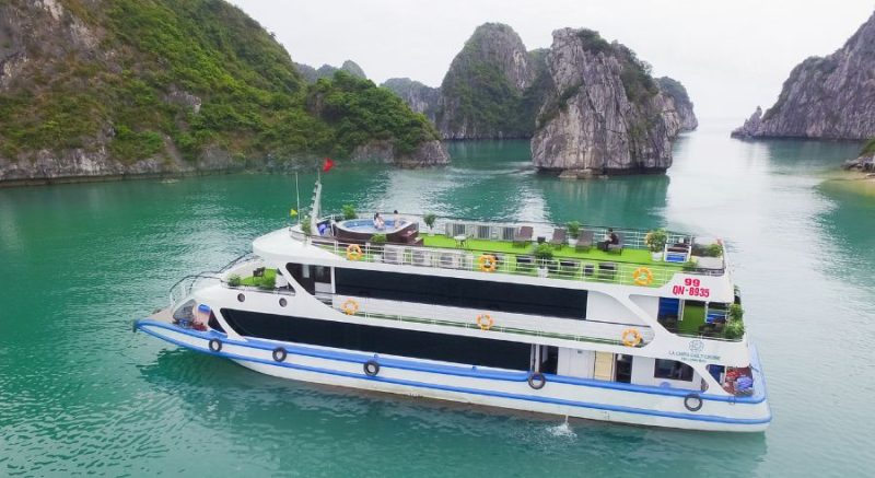 La Casta daily cruise luxury boat sailing in Ha Long Bay, surrounded by limestone karsts and clear blue waters