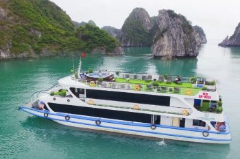 Luxury La Casta daily cruise on emerald waters of Ha Long Bay, surrounded by stunning limestone karsts.