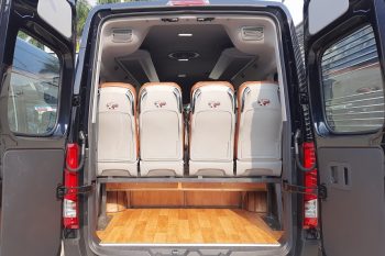 Rear view of a luxury limousine van showing spacious and comfortable seating for tours from Hanoi to Ha Long Bay