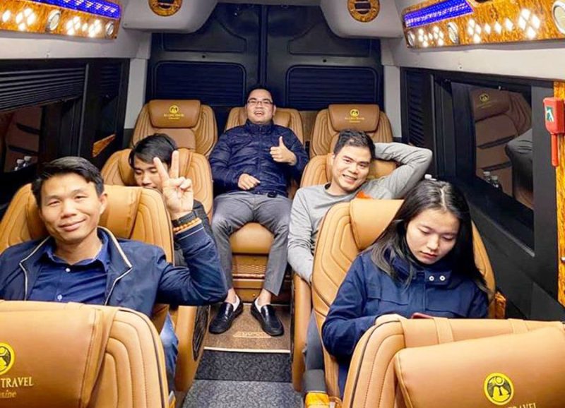 Group of happy tourists enjoying the comfortable interior of a limousine van on a tour from Hanoi to Ha Long Bay