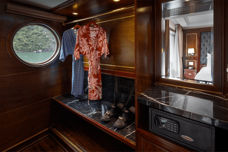 "Elegant interior with bathrobes and slippers in Paradise Elegance Cruise room, Halong Bay