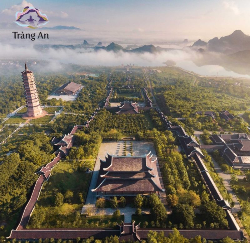 Aerial view of Trang An complex in Ninh Binh with ancient pagodas, lush greenery, and misty mountains in the background