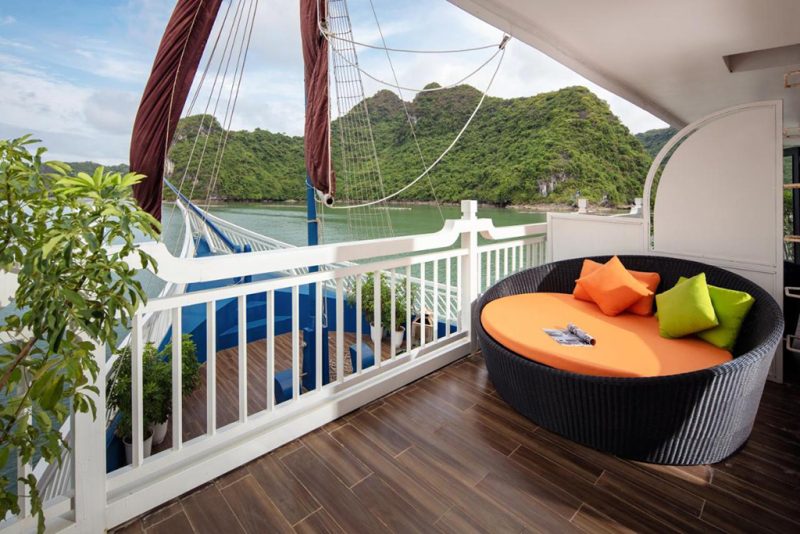 Luxurious outdoor seating area with scenic view of Ha Long Bay on the Verdure Lotus Cruise.