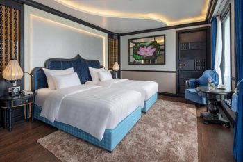 Luxurious twin bedroom with elegant decor and modern amenities on the Verdure Lotus Cruise in Ha Long Bay.