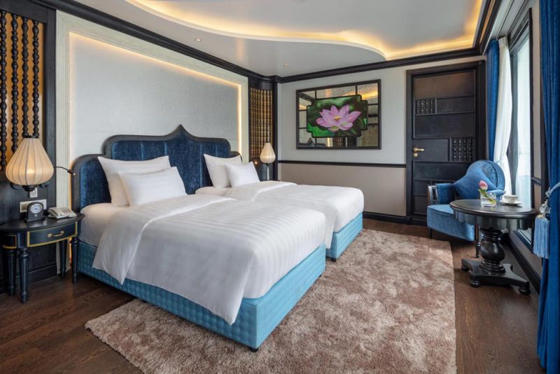 Luxurious twin bedroom with elegant decor and modern amenities on the Verdure Lotus Cruise in Ha Long Bay.