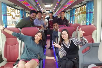 Happy passengers enjoying Luxco Travels' 35-seater shuttle bus from Hanoi to Halong Bay