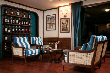 Cozy lounge area on Heritage Cruise Binh Chuan with a wine collection