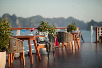 Outdoor seating area on the deck of Heritage Cruise Binh Chuan in Ha Long Bay