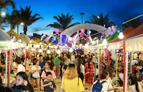 Busy night market in Ha Long Bay with tourists exploring and shopping