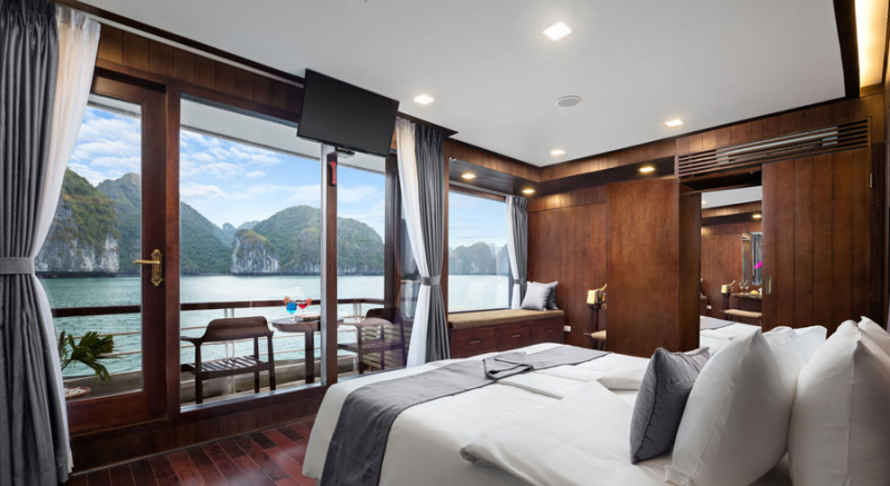 Luxurious bedroom with a balcony view on Orchid Classic Cruise in Ha Long Bay