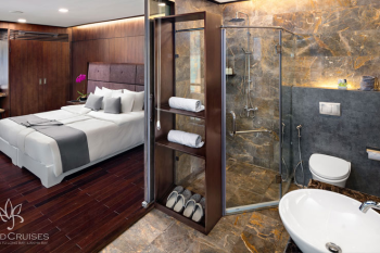 Luxurious bedroom and bathroom on Orchid Classic Cruise in Ha Long Bay