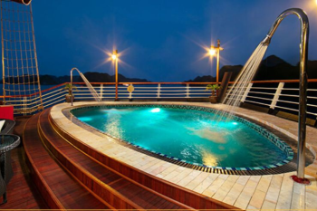 Luxurious onboard pool at night on the Orchid Trendy Cruise, Ha Long Bay, Vietnam - Perfect for relaxation and enjoying the scenic views