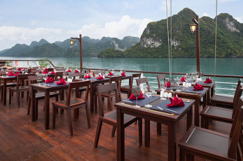 Outdoor dining area with stunning views on the Orchid Trendy Cruise, Ha Long Bay, Vietnam - Perfect for enjoying meals with breathtaking scenery