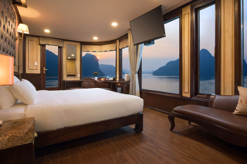 Luxurious cabin with panoramic views on the Orchid Trendy Cruise, Ha Long Bay, Vietnam - Featuring a comfortable bed and elegant decor