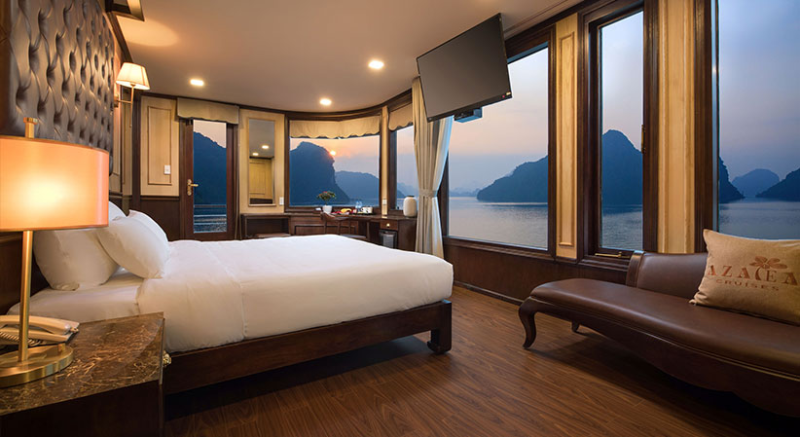 Luxurious cabin with panoramic views on the Orchid Trendy Cruise, Ha Long Bay, Vietnam - Featuring a comfortable bed and elegant decor