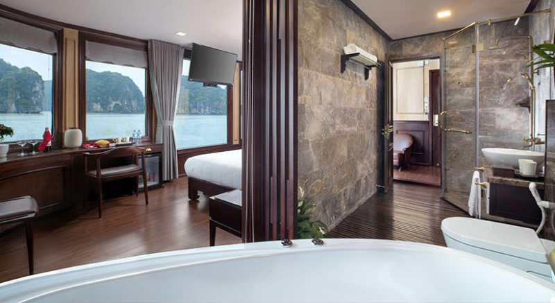 Luxurious suite with a view on the Orchid Trendy Cruise, Ha Long Bay, Vietnam - Featuring a spacious bathroom and comfortable bedroom.