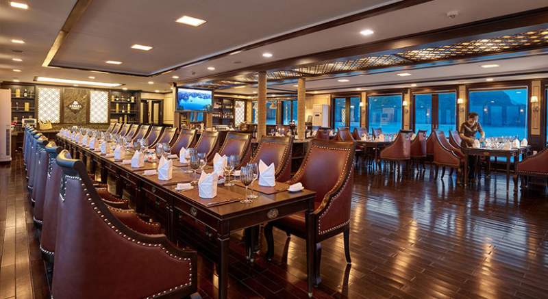 Elegant dining area on the Orchid Trendy Cruise, Ha Long Bay, Vietnam - Perfect for enjoying gourmet meals with stunning views.