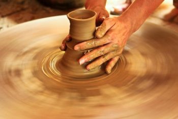 Participants creating ceramics and lacquer paintings at Bat Trang village, showcasing Vietnamese traditional crafts.