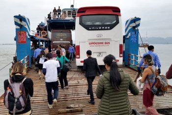 Passengers boarding Cat Ba Express Bus from Hanoi to Cat Ba at Ferry Terminal