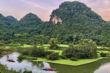 Small boats carrying tourists for bird watching at Thung Nham, showcasing the serene natural beauty of Vietnam.