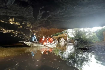 Small boats carrying tourists through a cave at Thung Nham, showcasing the natural beauty and adventure of Vietnam.