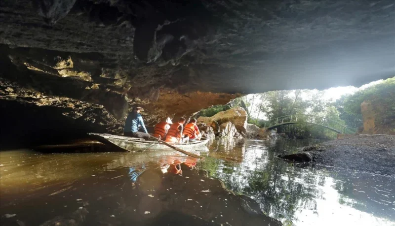 Small boats carrying tourists through a cave at Thung Nham, showcasing the natural beauty and adventure of Vietnam.