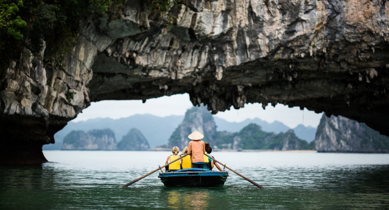 Tourists in a boat exploring a cave in Ha Long Bay