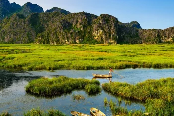 Stunning mountain and water scenery at Van Long Natural Reserve, showcasing Vietnam's natural beauty.