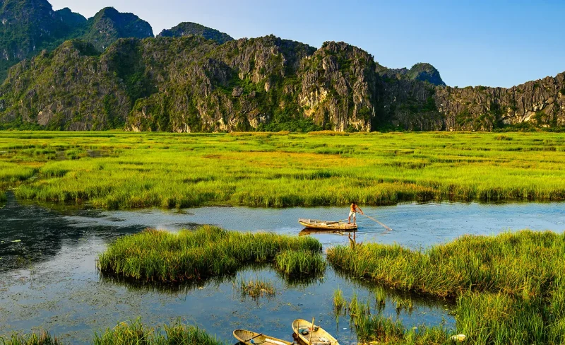 Stunning mountain and water scenery at Van Long Natural Reserve, showcasing Vietnam's natural beauty.